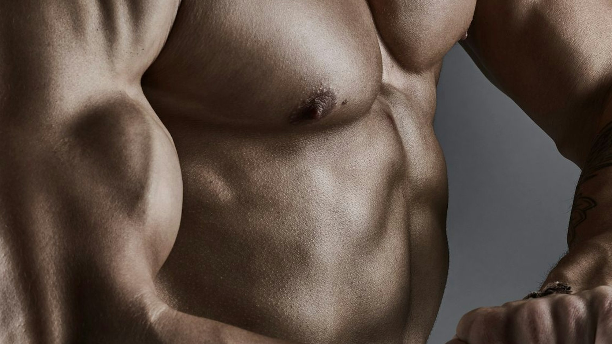 Portrait of athletic bodybuilders, healthy and muscular torso. With tensing biceps.