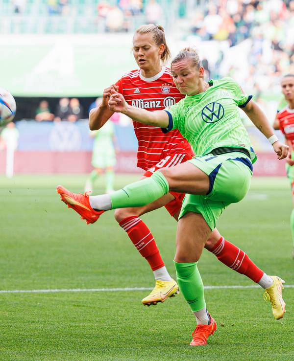 Wolfsburgs Alexandra Popp (r) schießt neben Münchens Maximiliane Rall (l).