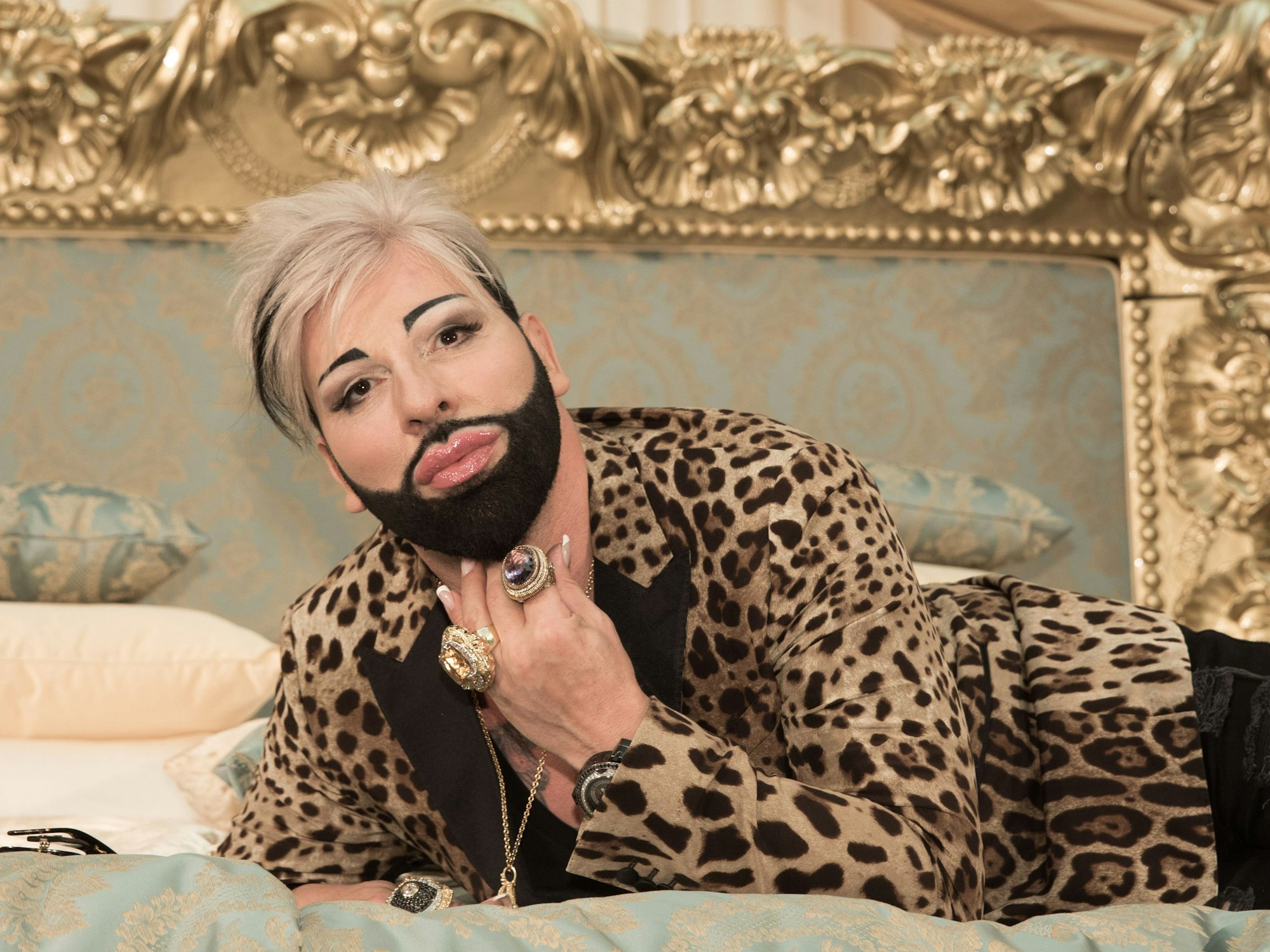 Harald Glööckler, hier auf einem Bett im Juni 2017 in Berlin, ließ für ein Kunstprojekt die Hüllen fallen.