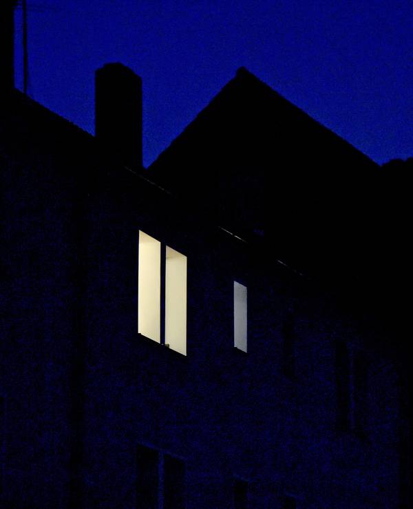 Zeugen hatten beobachtet, wie der Junge auf dem Dach herumkletterte. Unser Symbolfoto zeigt Licht in einer Wohnung im obersten Stock eines Hauses.