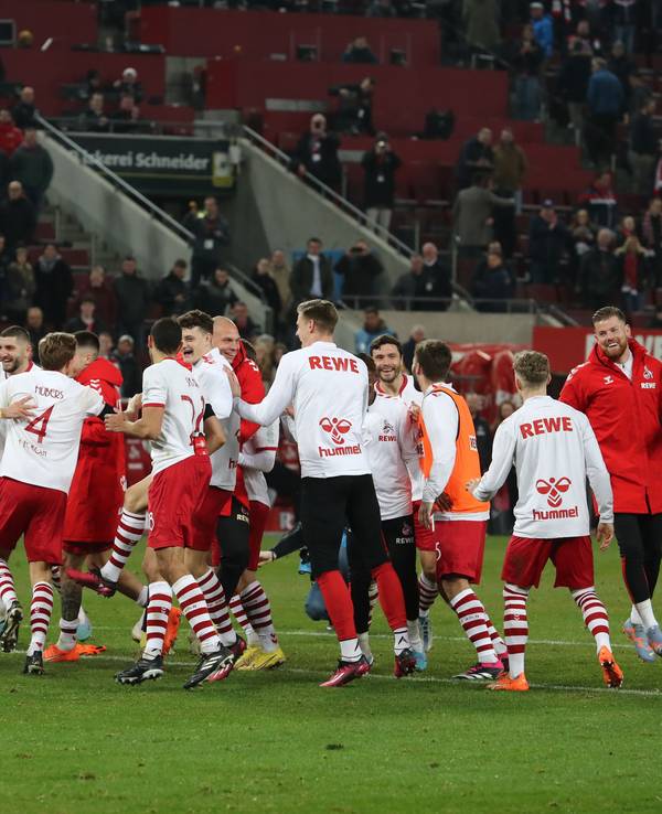 Die Profis des 1. FC Köln tanzen vor der Südkurve.