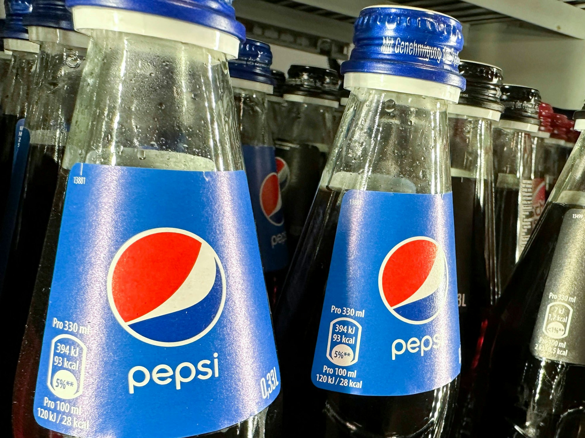Pepsi-Flaschen in einem Regal.