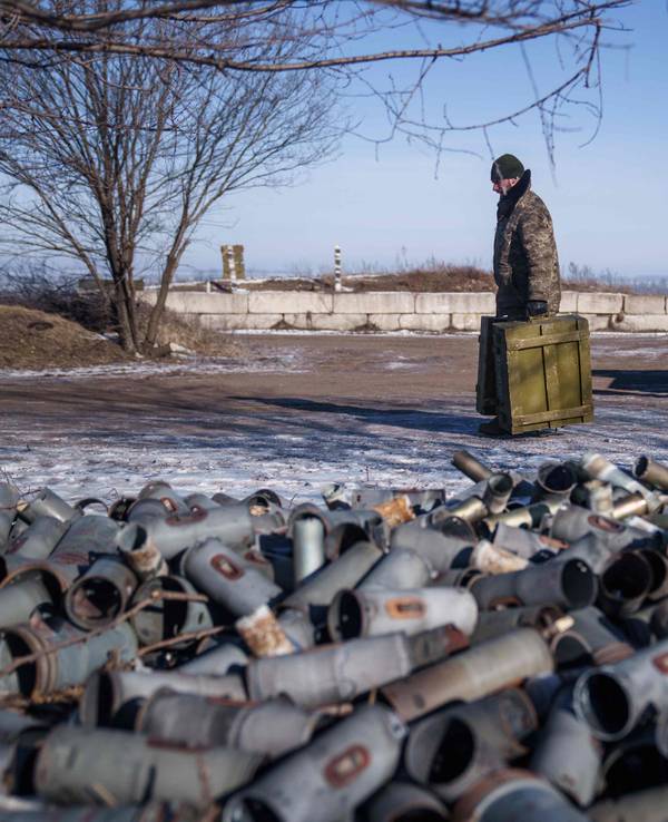 TOPSHOT - A Helicopter crew member of the 18th Separate Army Aviation Brigade carries boxes of ammunition, in eastern Ukraine on February 9, 2023 amid Russia's military invasion on Ukraine. (Photo by Ihor Tkachov / AFP)