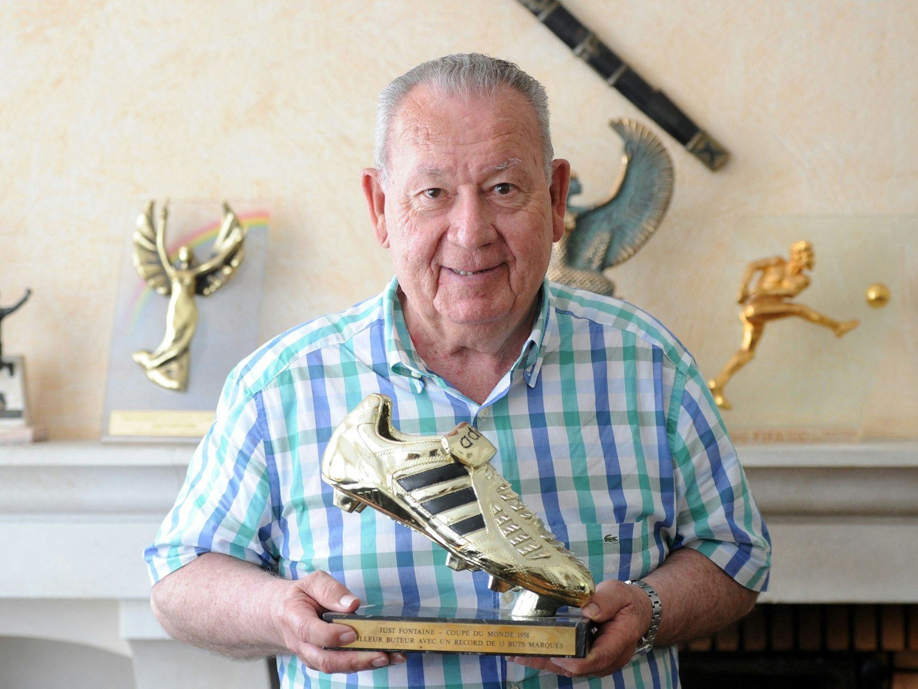 Frankreich Fußball-Ikone Just Fontaine hält eine goldene Trophäe für den Rekordtorschützen bei der WM 1958 in der Hand.