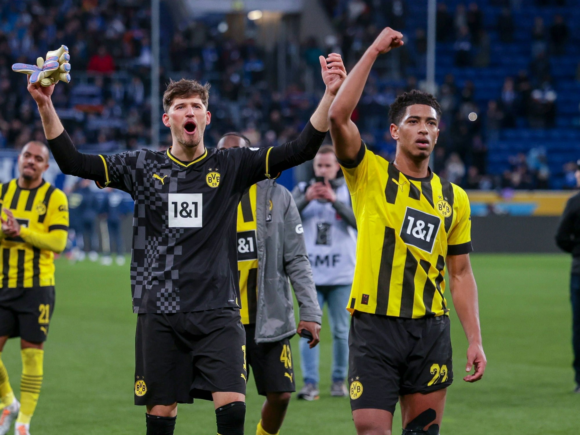 Dortmunds Gregor Kobel (l.) und Jude Bellingham jubeln nach dem Spiel gegen Hoffenheim in Richtung Fans.