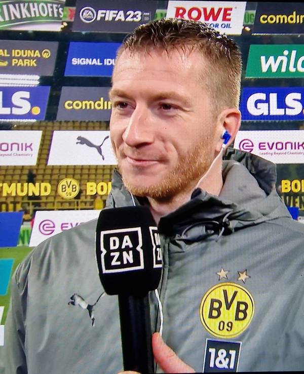 Marco Reus steht nach dem BVB-Sieg gegen RB Leipzig im DAZN-Interview vor einer Sponsorenwand.