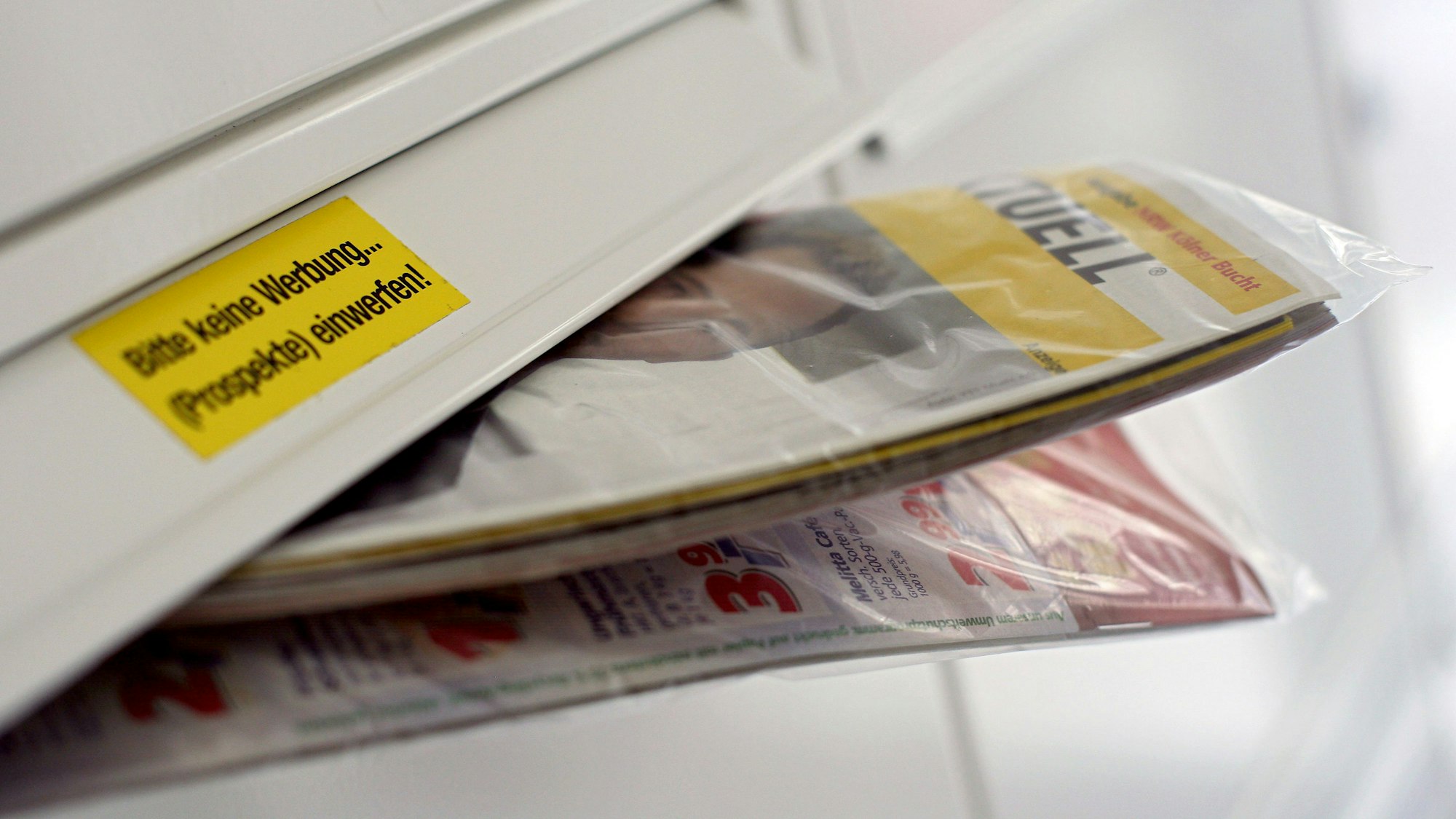 Eine Gratis-Werbezeitung steckt in einem Briefkasten.