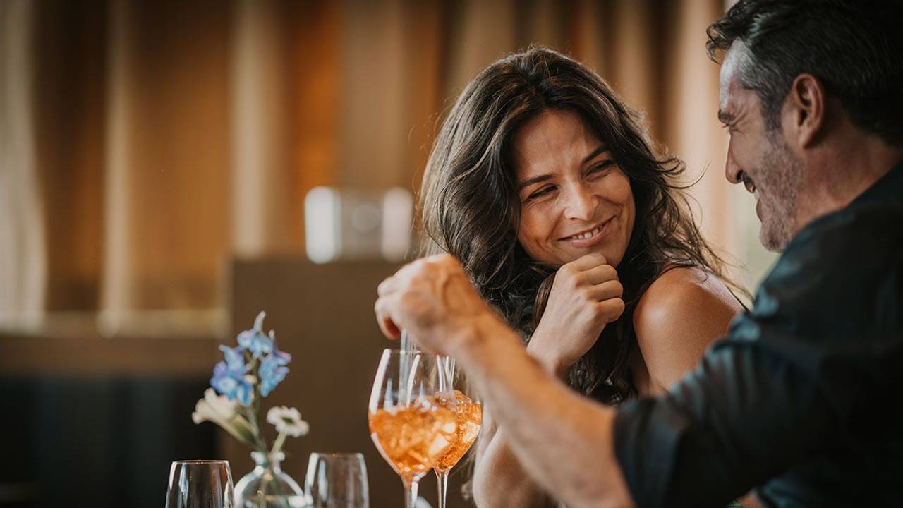 Glückliche Frau und Mann in einer Bar mit Getränk
