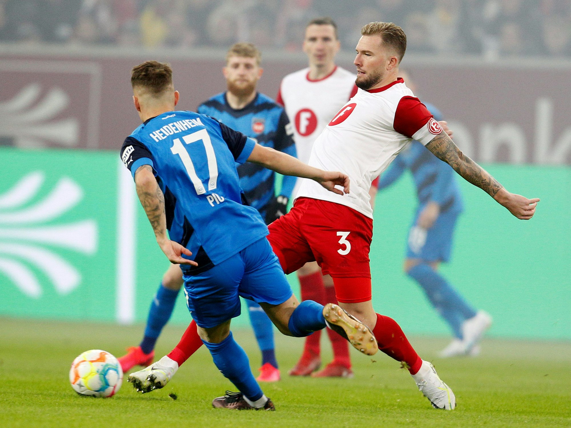 Der Düsseldorfer Andre Hoffmann und der Heidenheimer Florian Pick kämpfen um den Ball.