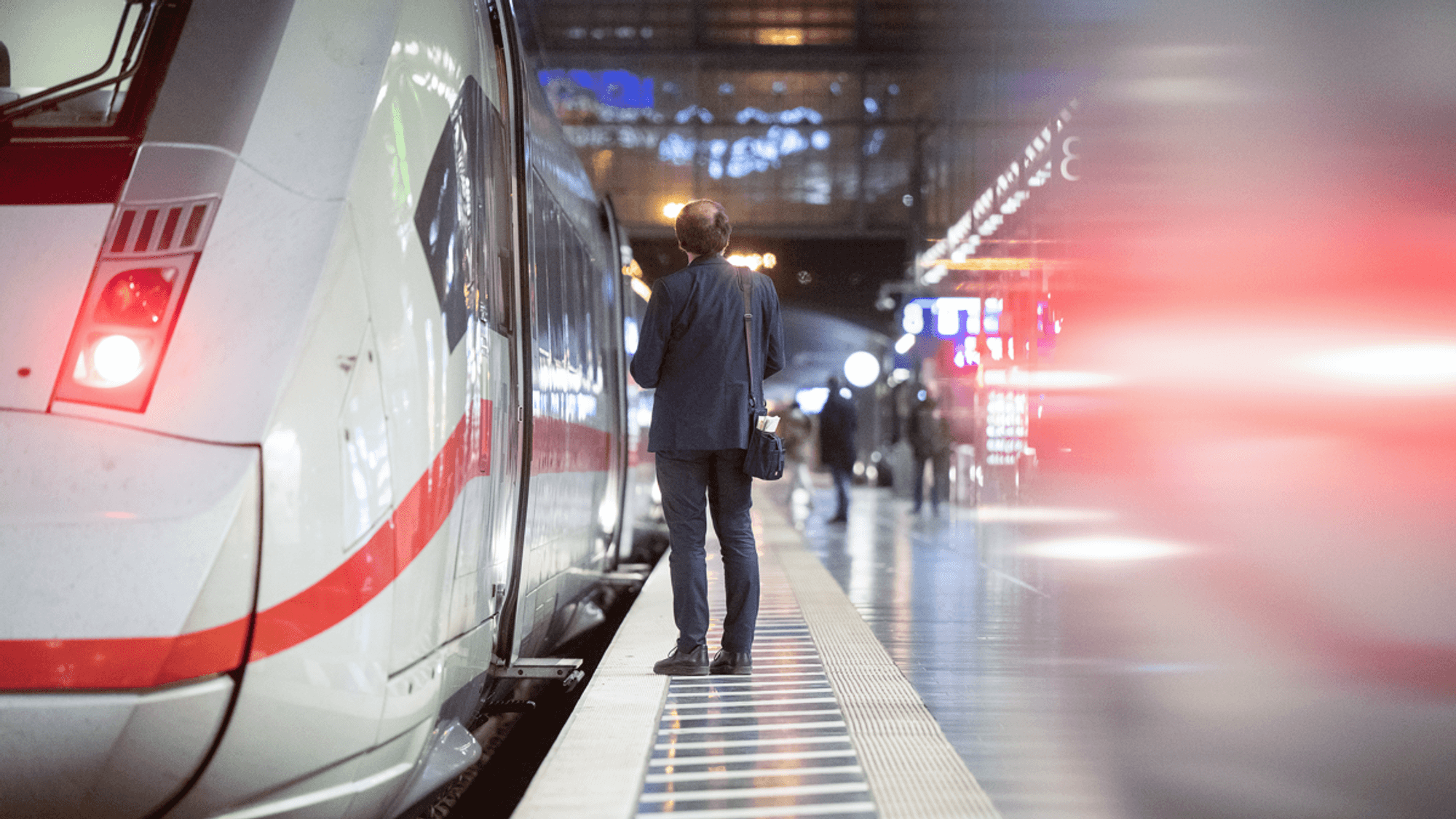 Ein Zugbegleiter steht am Hauptbahnhof an einem ICE.