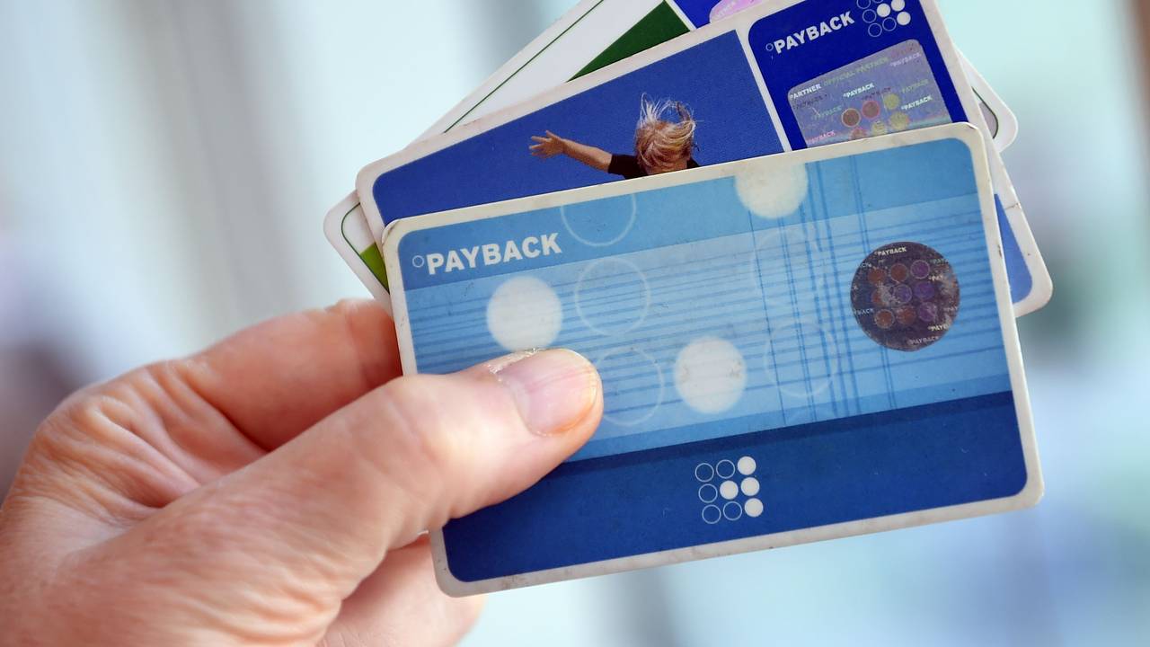 Das Symbolfoto aus dem Jahr 2016 zeigt eine Hand, die drei blaue Payback-Karten hält.