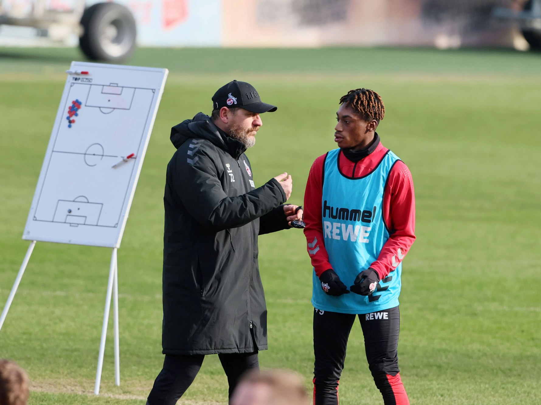 Steffen Baumgart redet mit Justin Diehl im Training.