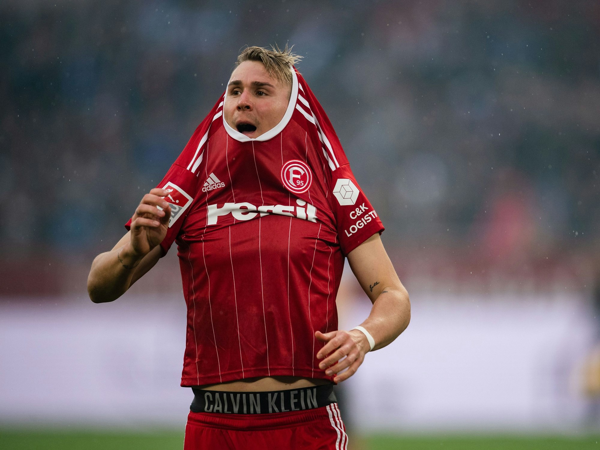 Felix Klaus zieht sich das Trikot über den Kopf.