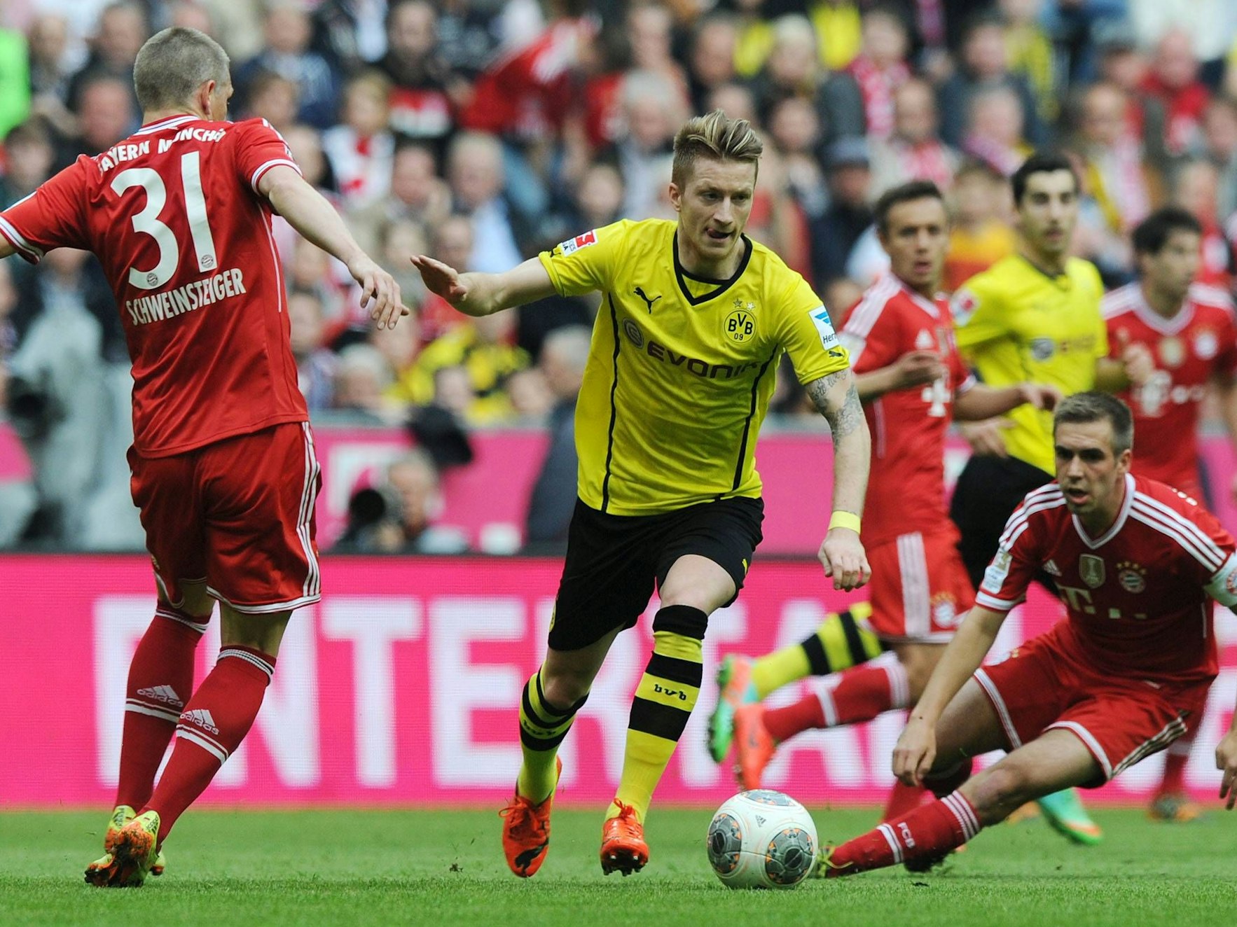v.li., Bastian Schweinsteiger, Marco Reus und Philipp Lahm im Klassiker auf dem Spielfeld.