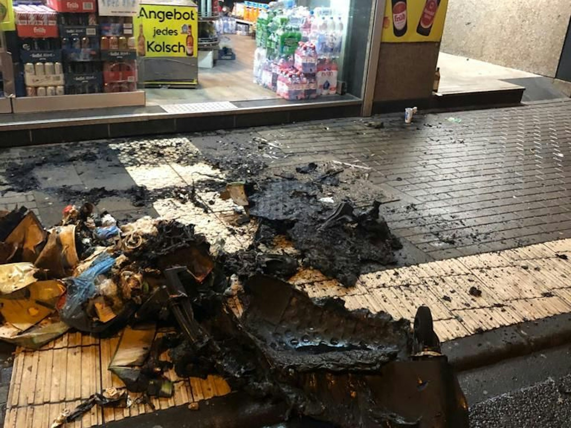 Verbranntes Plastik liegt am Straßenrand.