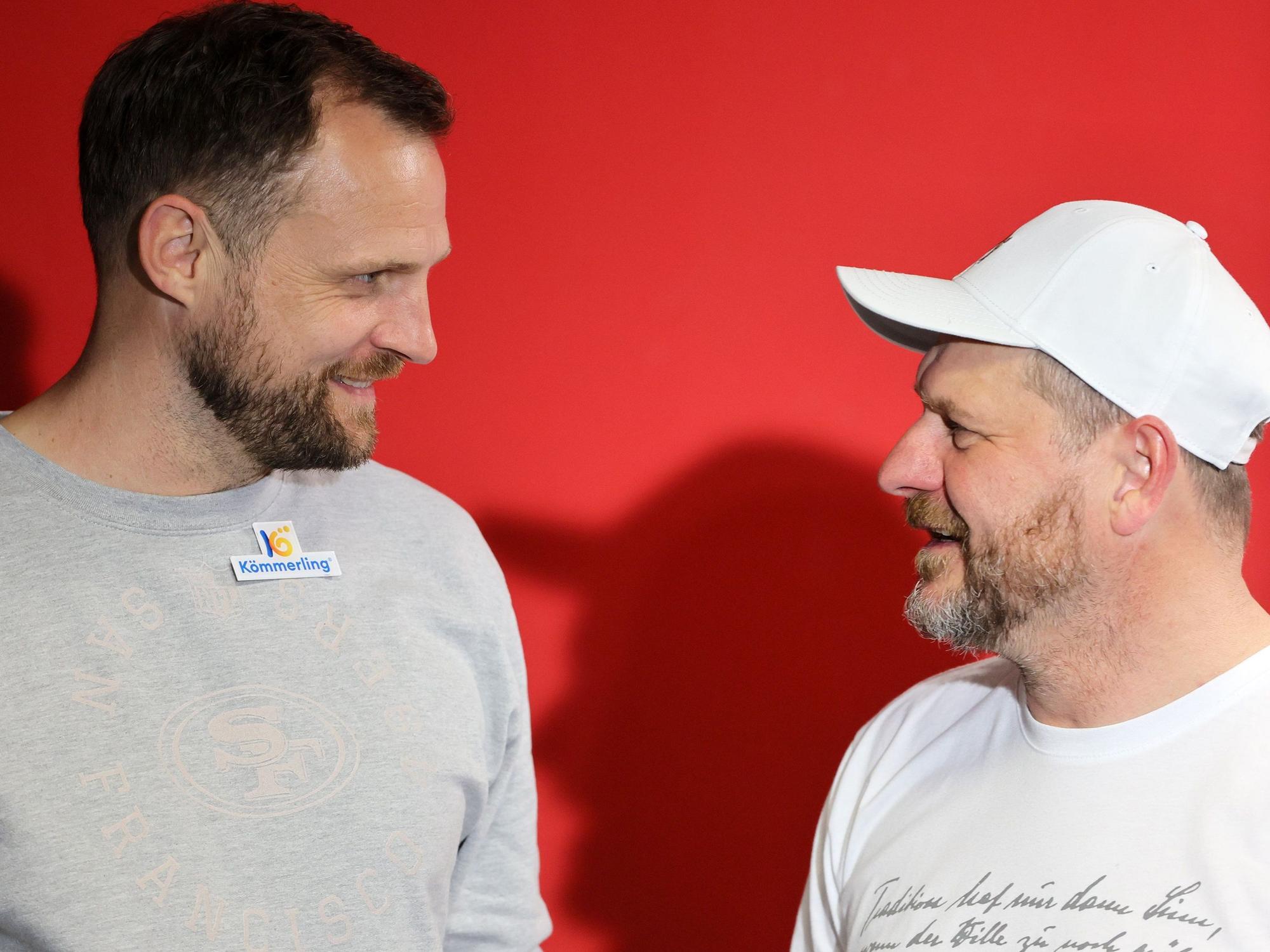 Bo Svensson und Steffen Baumgart lächeln sich nach der Pressekonferenz an.