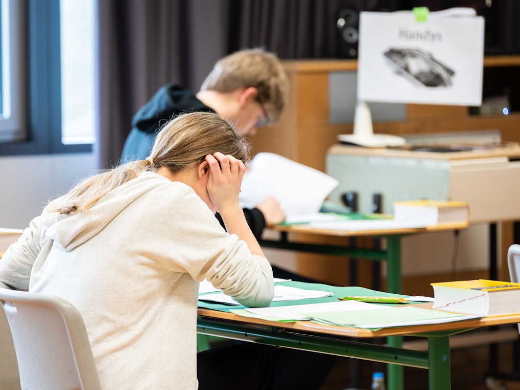 Schülerinnen und Schüler sitzen während der schriftlichen Abiturprüfung in Biologie in einem Klassenzimmer im Leibniz-Gymnasium.