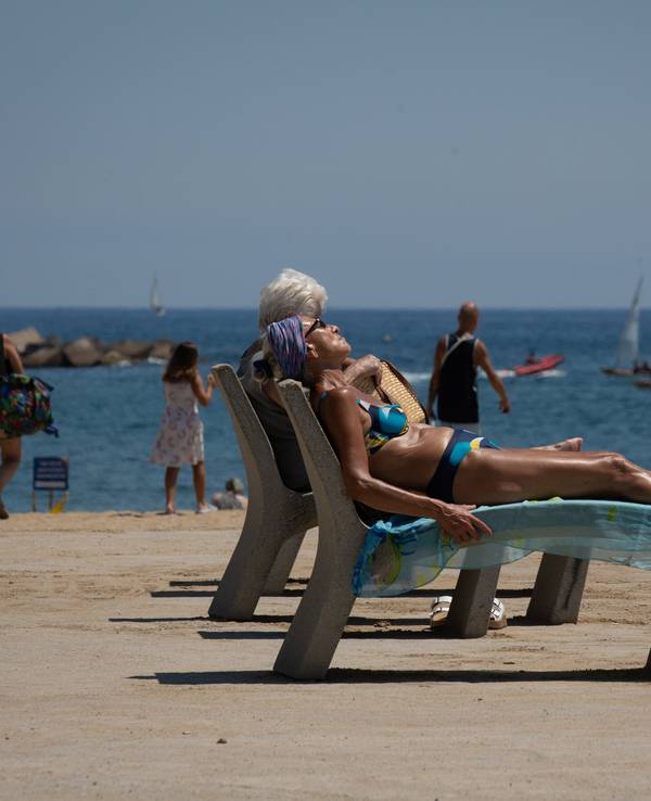Mehrere Personen sonnen sich am Strand von Barceloneta. Die Temperaturen in Spanien klettern angesichts der aktuellen Hitzewelle auf Spitzenwerte. +++ dpa-Bildfunk +++