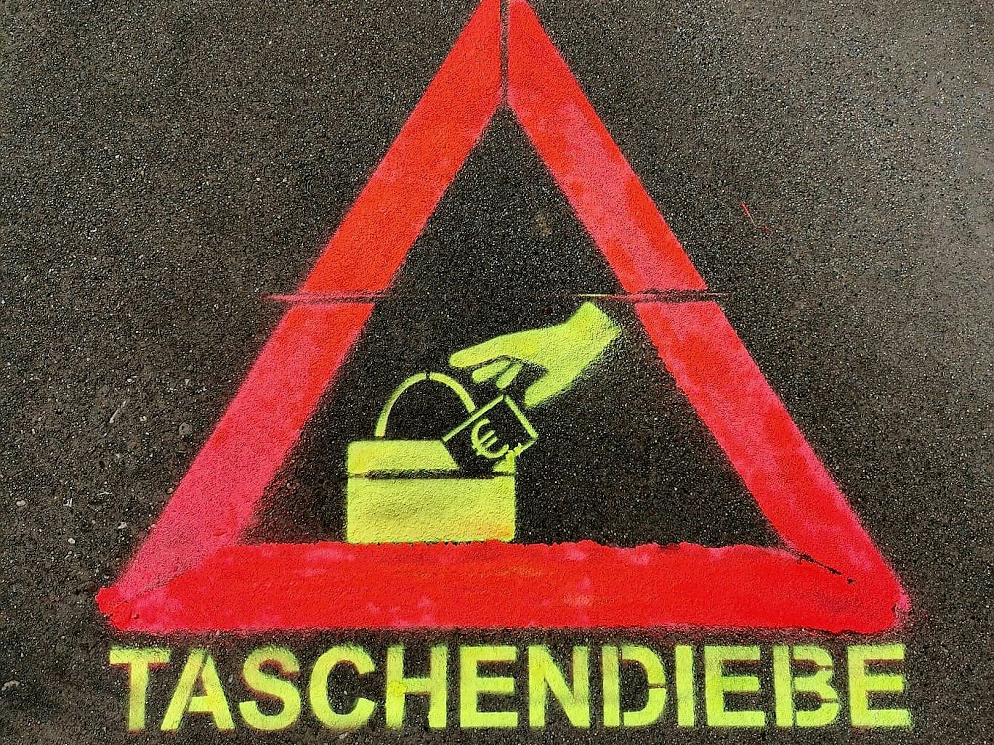 Ein Piktogramm zeigt ein Dreieck mit einer Hand, die nach einem Geldschein greift. Darunter steht das Wort Taschendiebe.