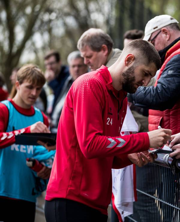 Jeff Chabot schreibt nach dem Training des 1. FC Köln Autogramme.