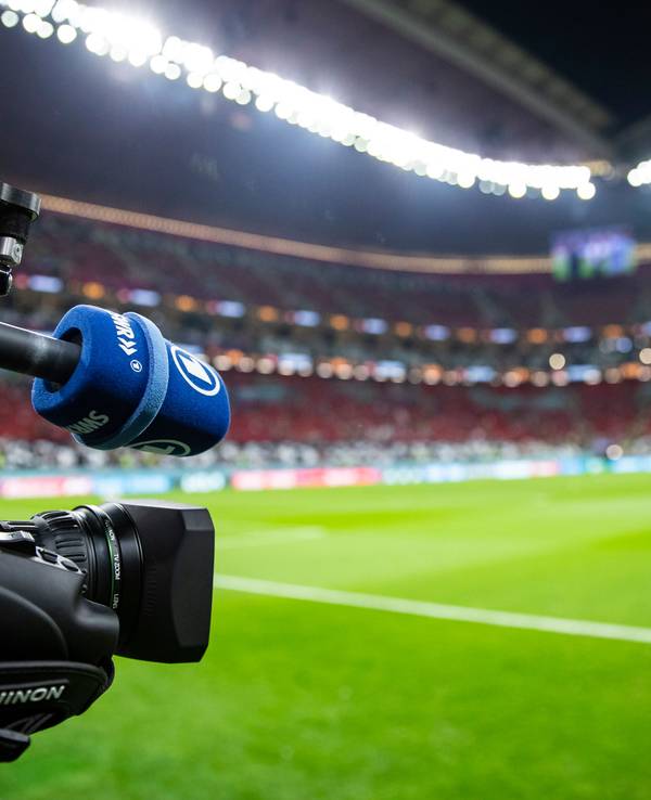 Eine TV-Kamera der ARD steht am Spielfeldrand vor dem Spiel.