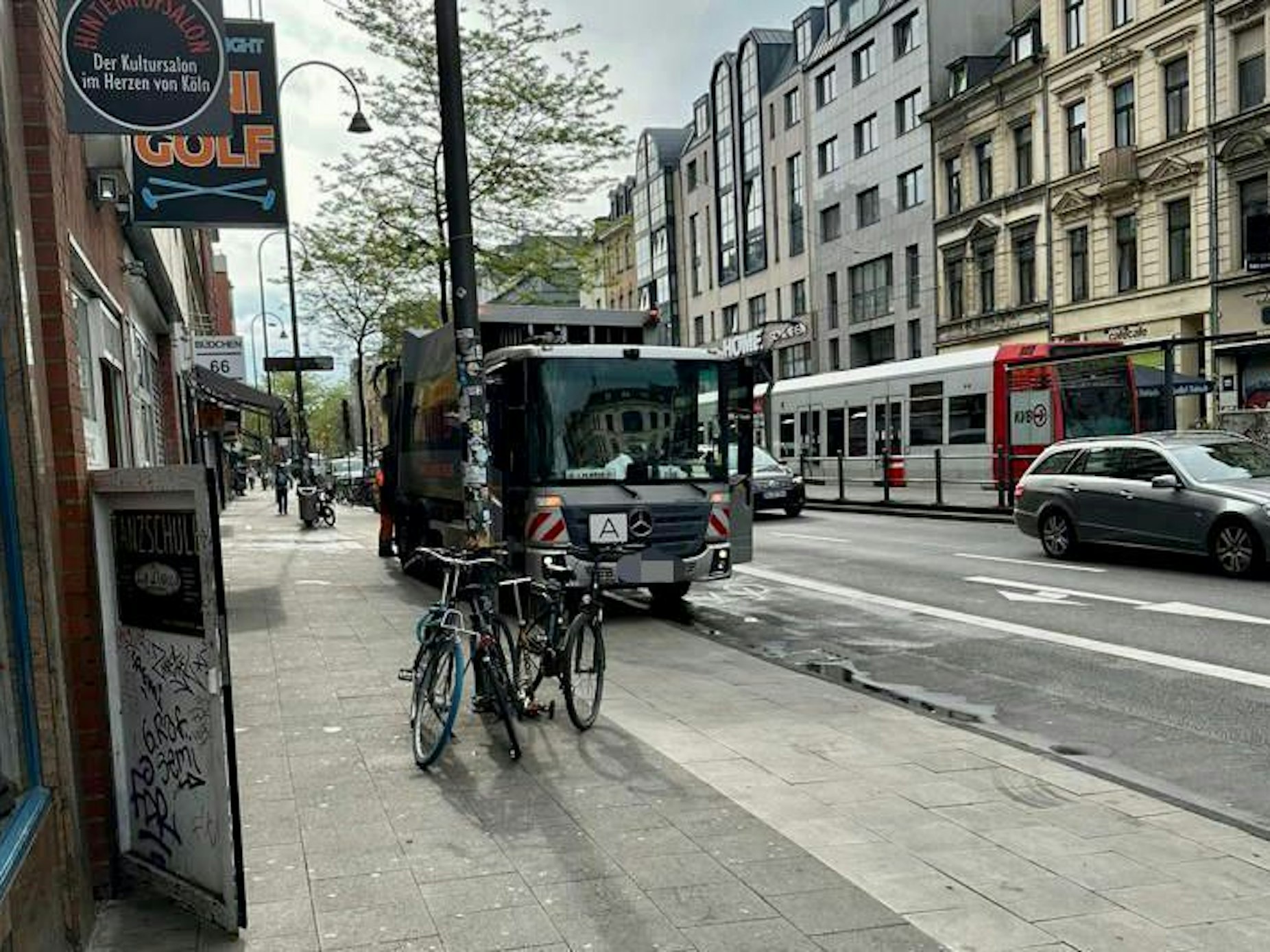Ein Müllwagen steht auf dem Gehweg der Aachener Straße.