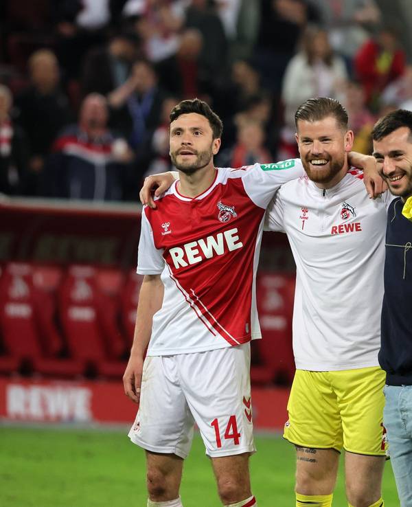 Die Profis des 1. FC Köln stehen Arm in Arm vor der Südkurve.