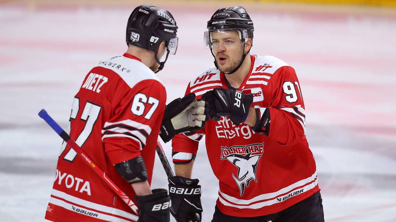 Stanislav Dietz (l.) und Moritz Müller von Kölner Haie klatschen sich ab.