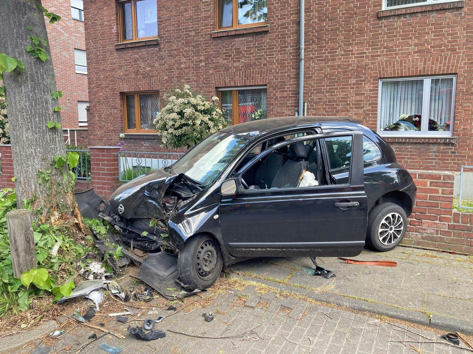 Das Unfallauto eingeklemmt zwischen Baum und Mauer.