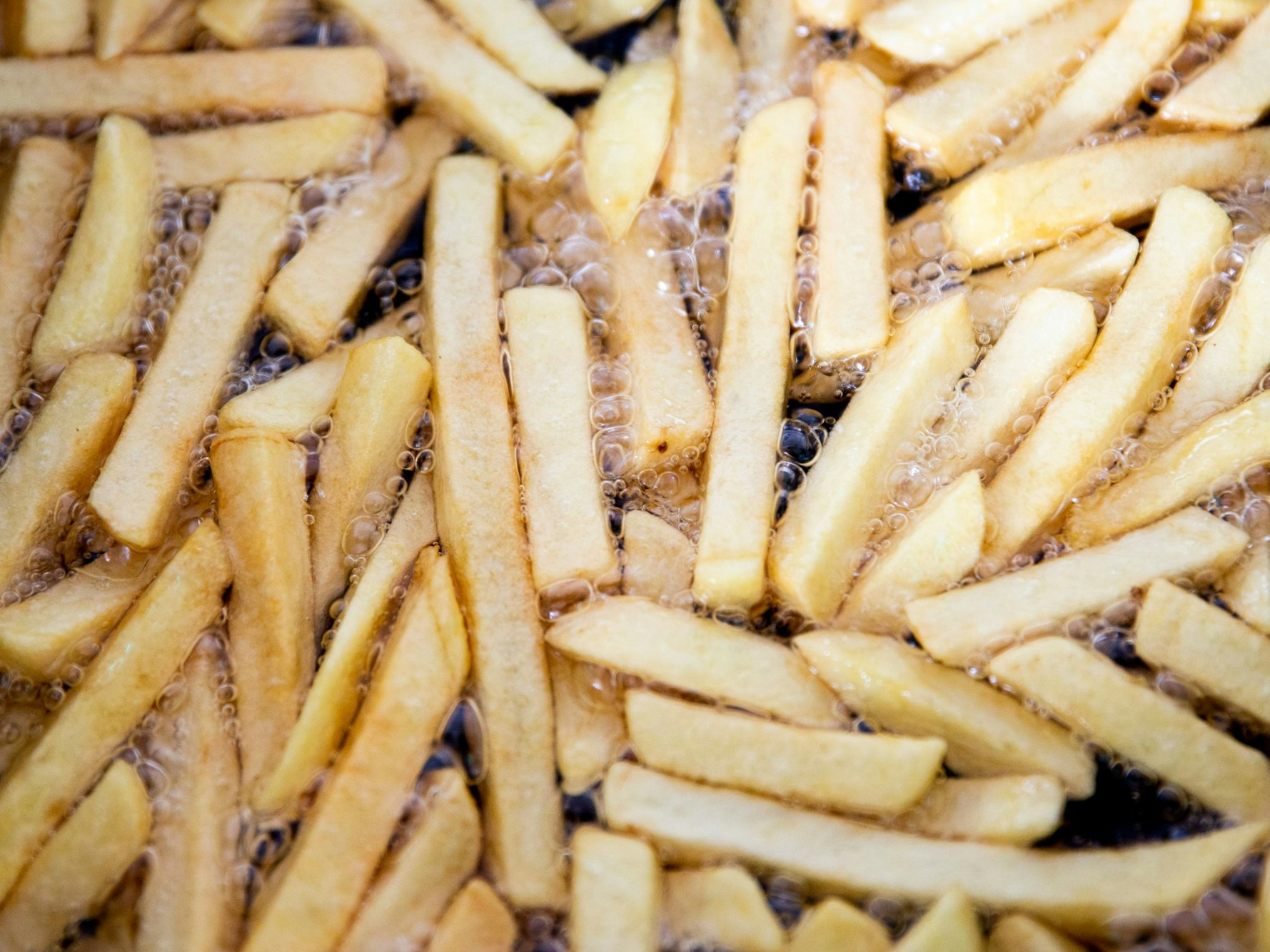 Pommes brutzeln in einer Fritteuse, hier im Juni 2020.