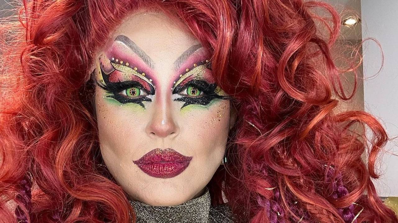 Moderatorin Nina Moghaddam als Drag-Queen mit buntem Make-up und roter Perücke bei der Show „Viva la Diva – Wer ist die Queen?“.