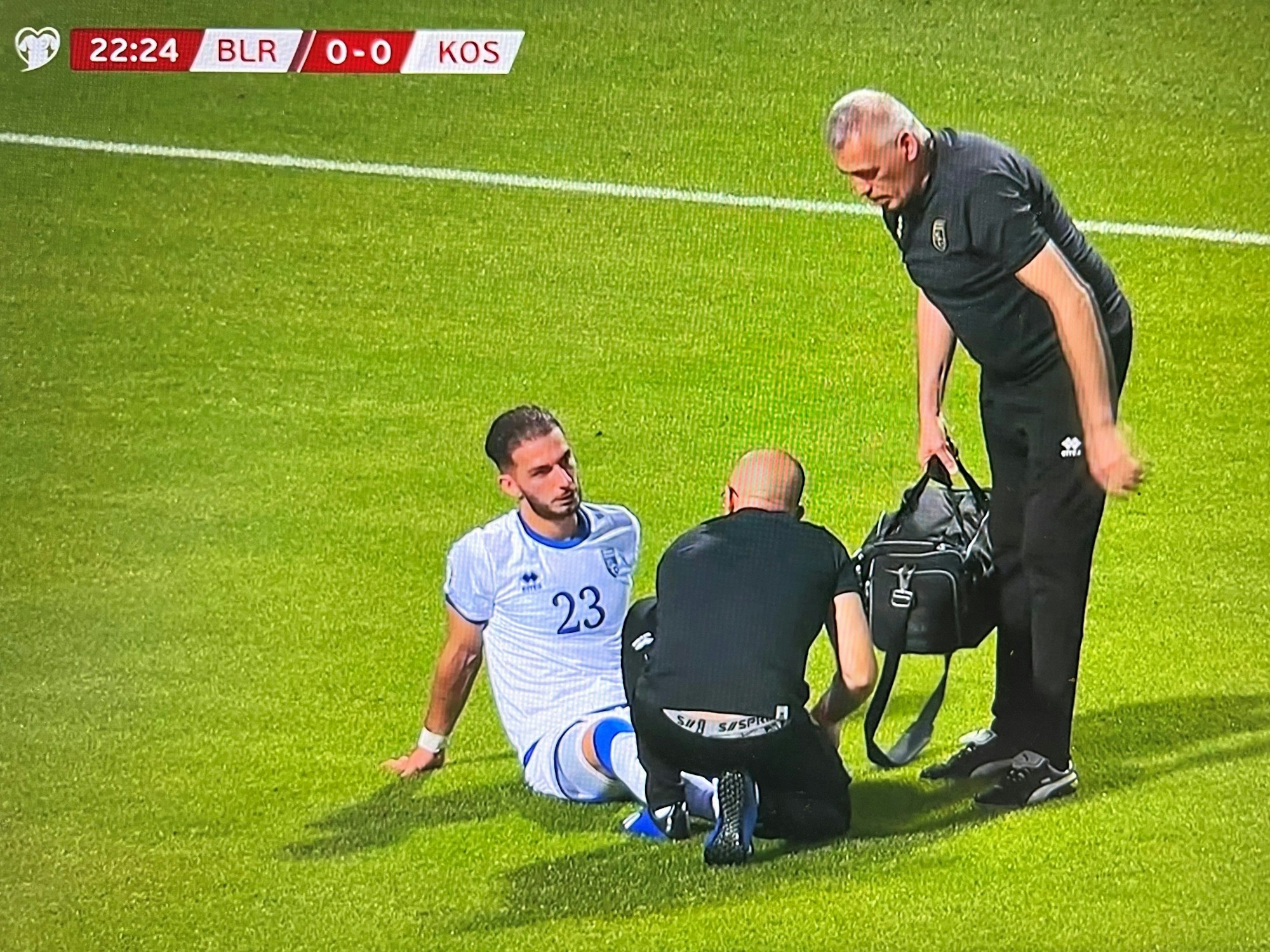 Leart Paqarada sitzt verletzt auf dem Rasen.