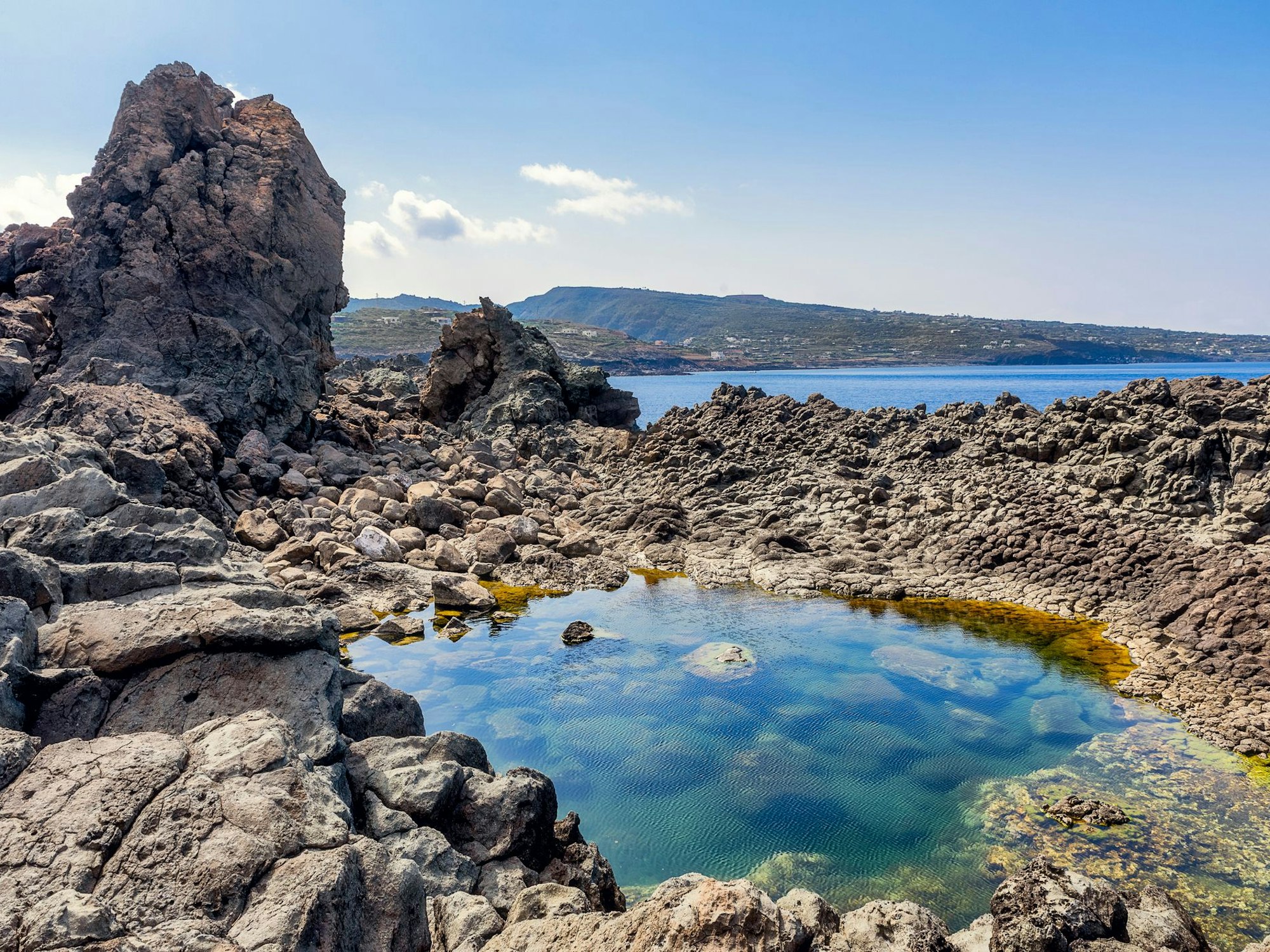 In einer Steinbucht sammelt sich Wasser.