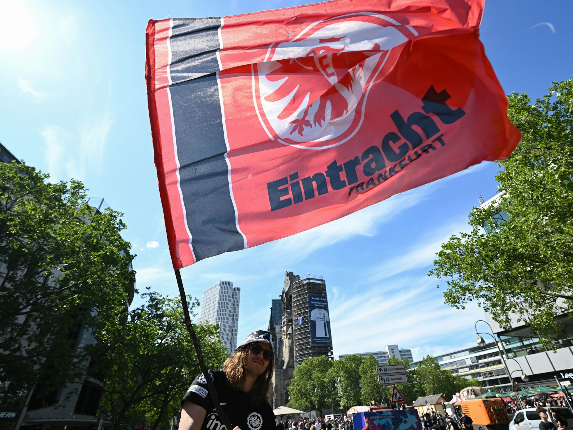 Ein Fan von Eintracht Frankfurt schwenkt seine Fahne beim Fanfest nahe der Gedächtniskirche in Berlin.