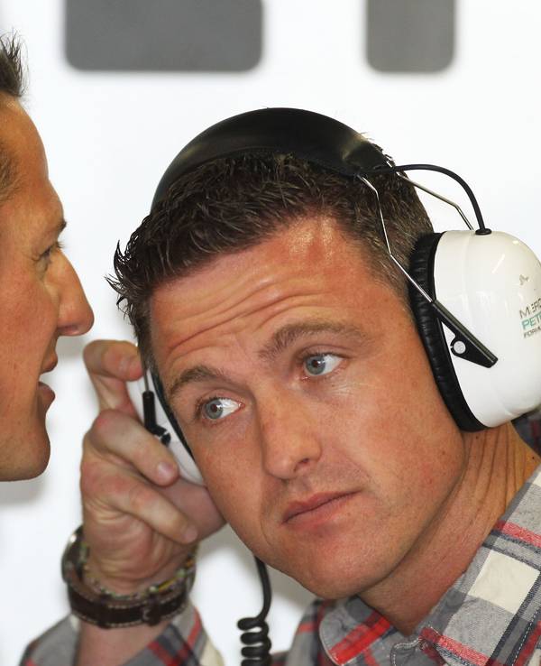 Michael Schumacher (l) von Mercedes GP spricht im zweiten Training auf der Formel-1-Rennstrecke von Suzuka in Japan mit seinem jüngeren Bruder Ralf.