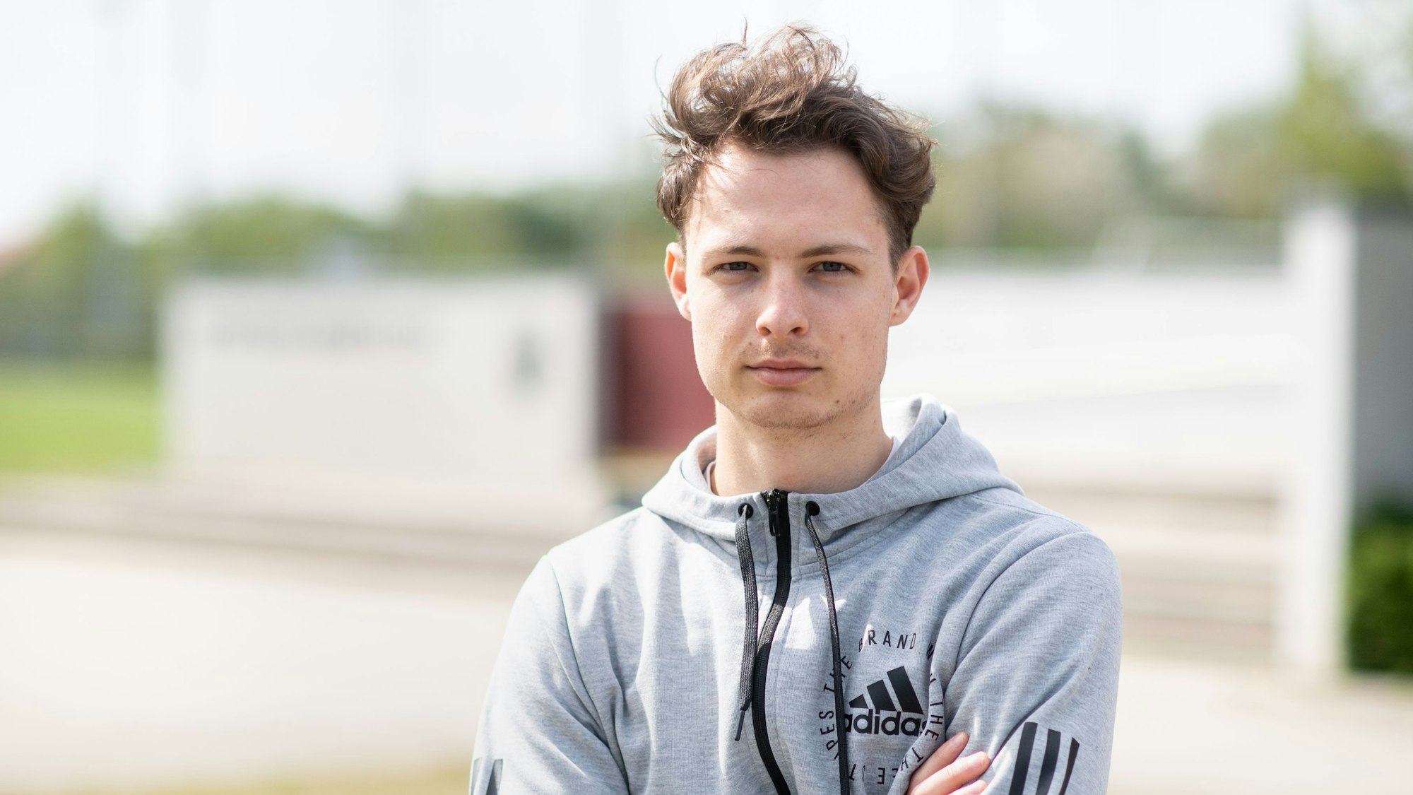 Luca Beckenbauer, Fußballspieler, blickt vor dem Trainingsgelände des Vereins SV Heimstetten in die Kamera.