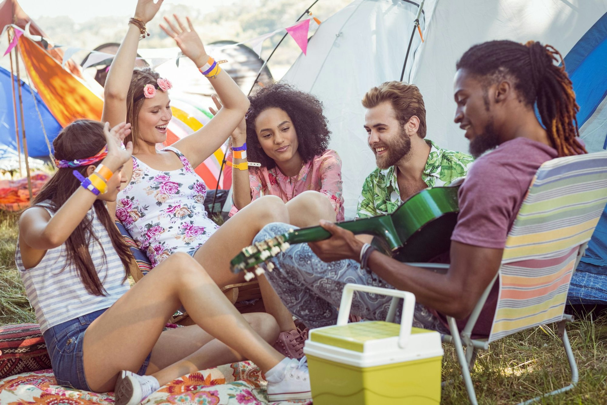 Hipsters having fun in their campsite at a music festival