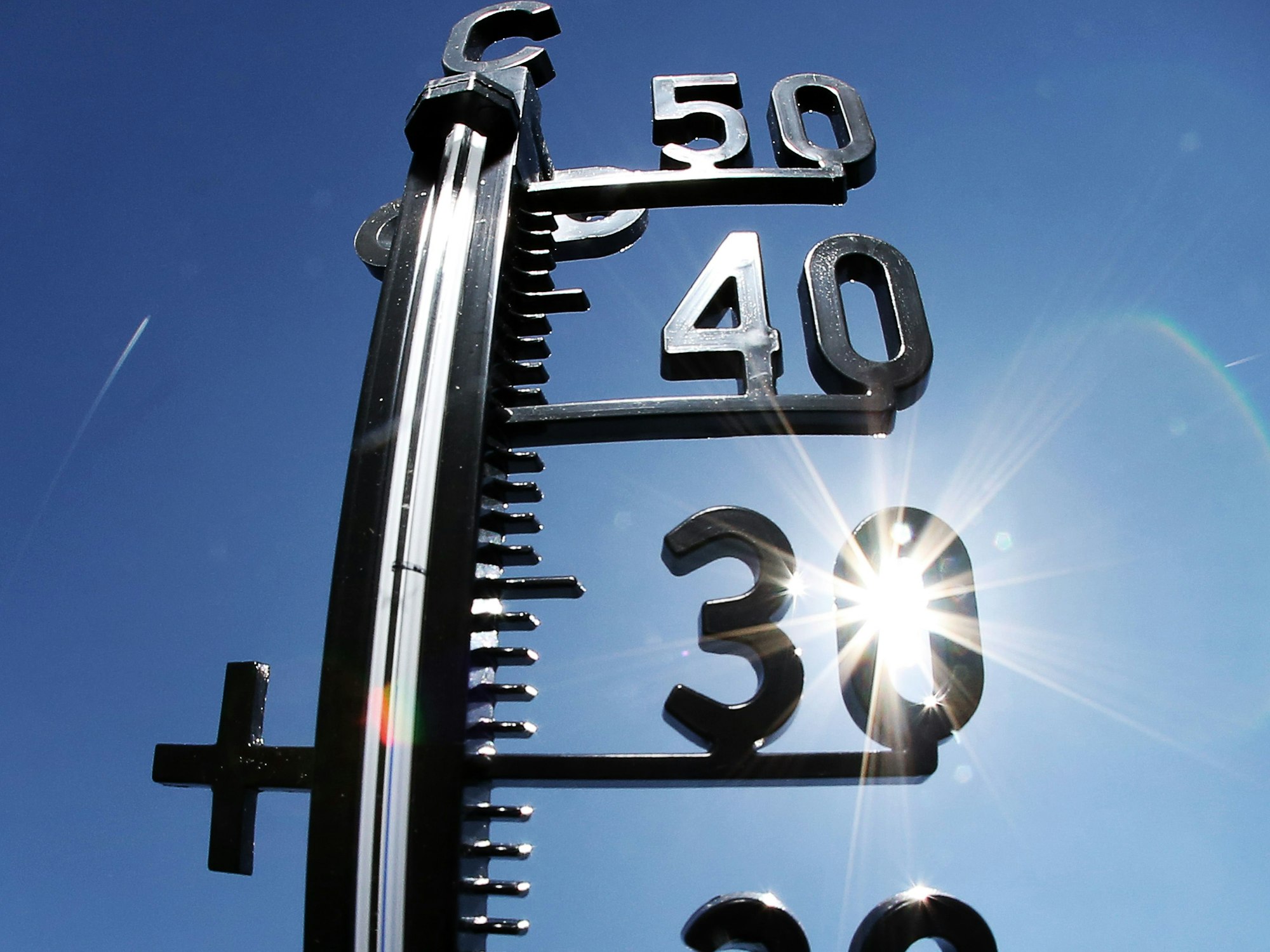 Die Sonne strahlt durch ein Thermometer, hier in Wiesbaden im Juni 2015.