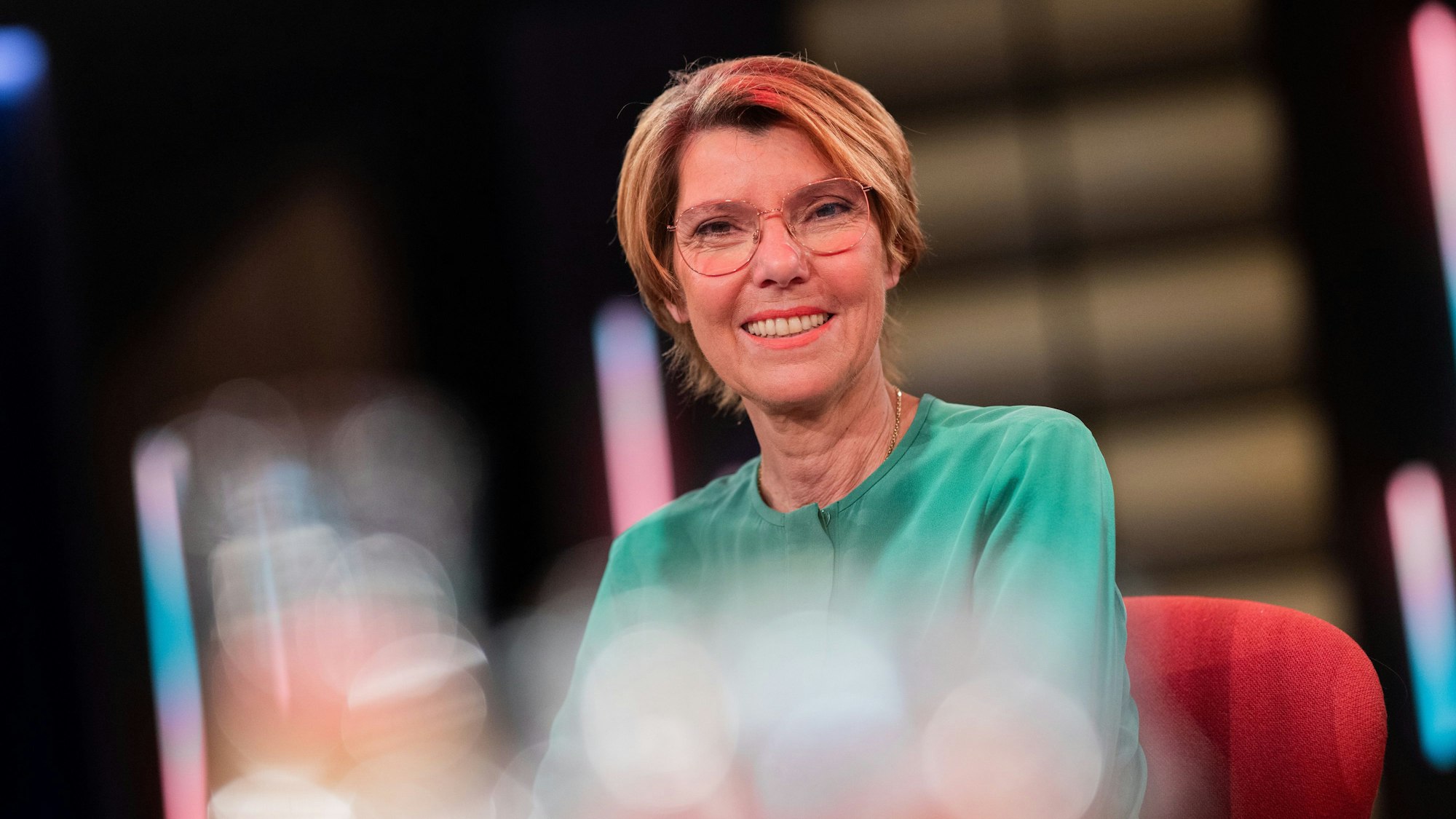 Bettina Böttinger sitzt bei einer Aufzeichnung des Kölner Treffs in einem Studiostuhl und lächelt in die Kamera.