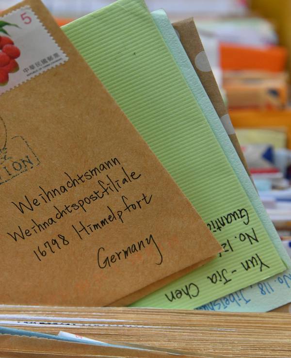 Bunte Briefumschläge in einer Postfiliale.