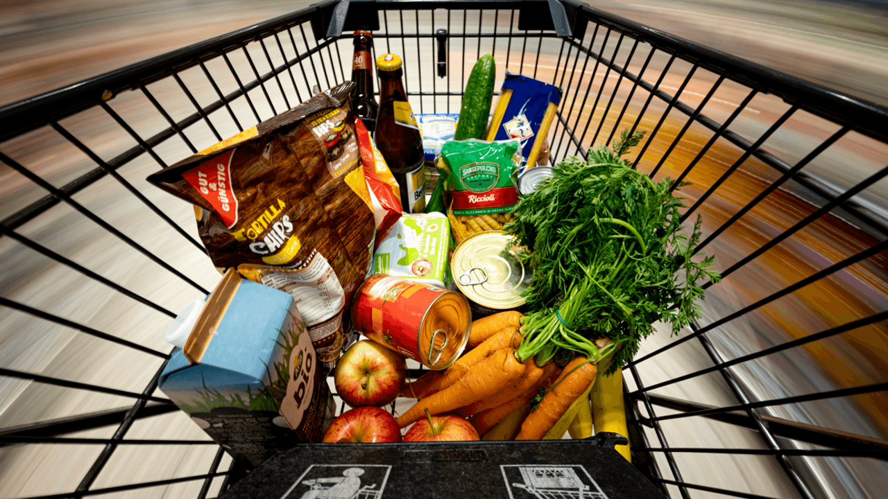 Ein Einkauf liegt in einem Einkaufswagen in einem Supermarkt.