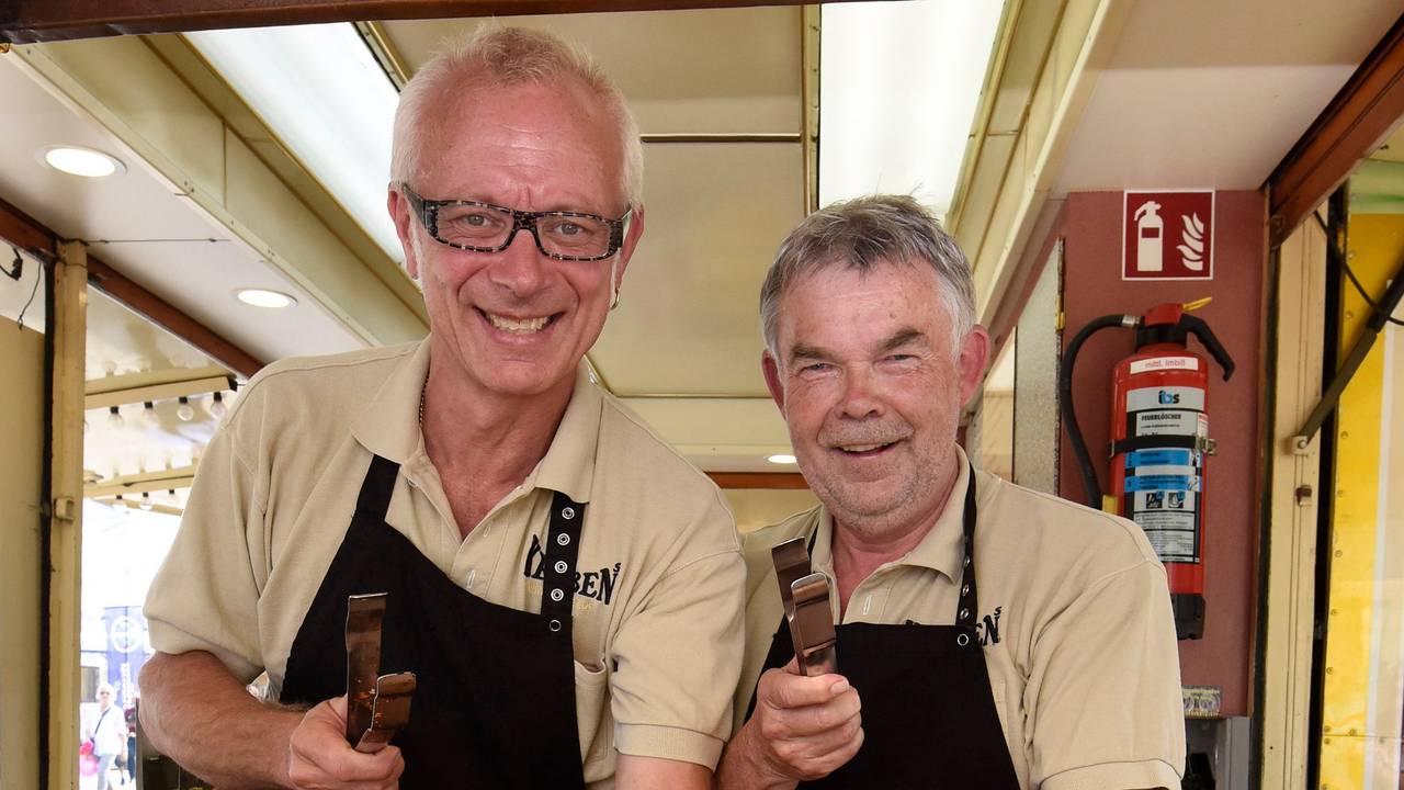 Auch Moderatoren-Legenden stehen auf die Kebben-Würstchen, wie Manni Breuckmann (r.), der Willi Kebben schon mal beim Verkauf auf der Kirmes half.