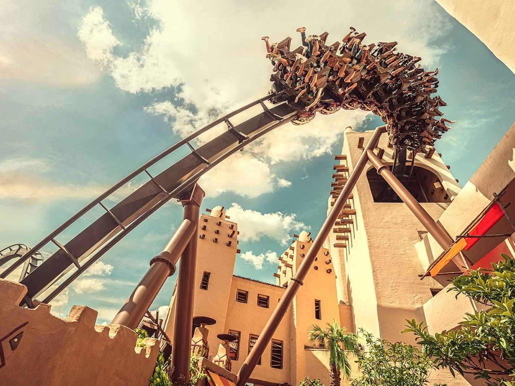 Eine Achterbahn fährt in einem Freizeitpark.