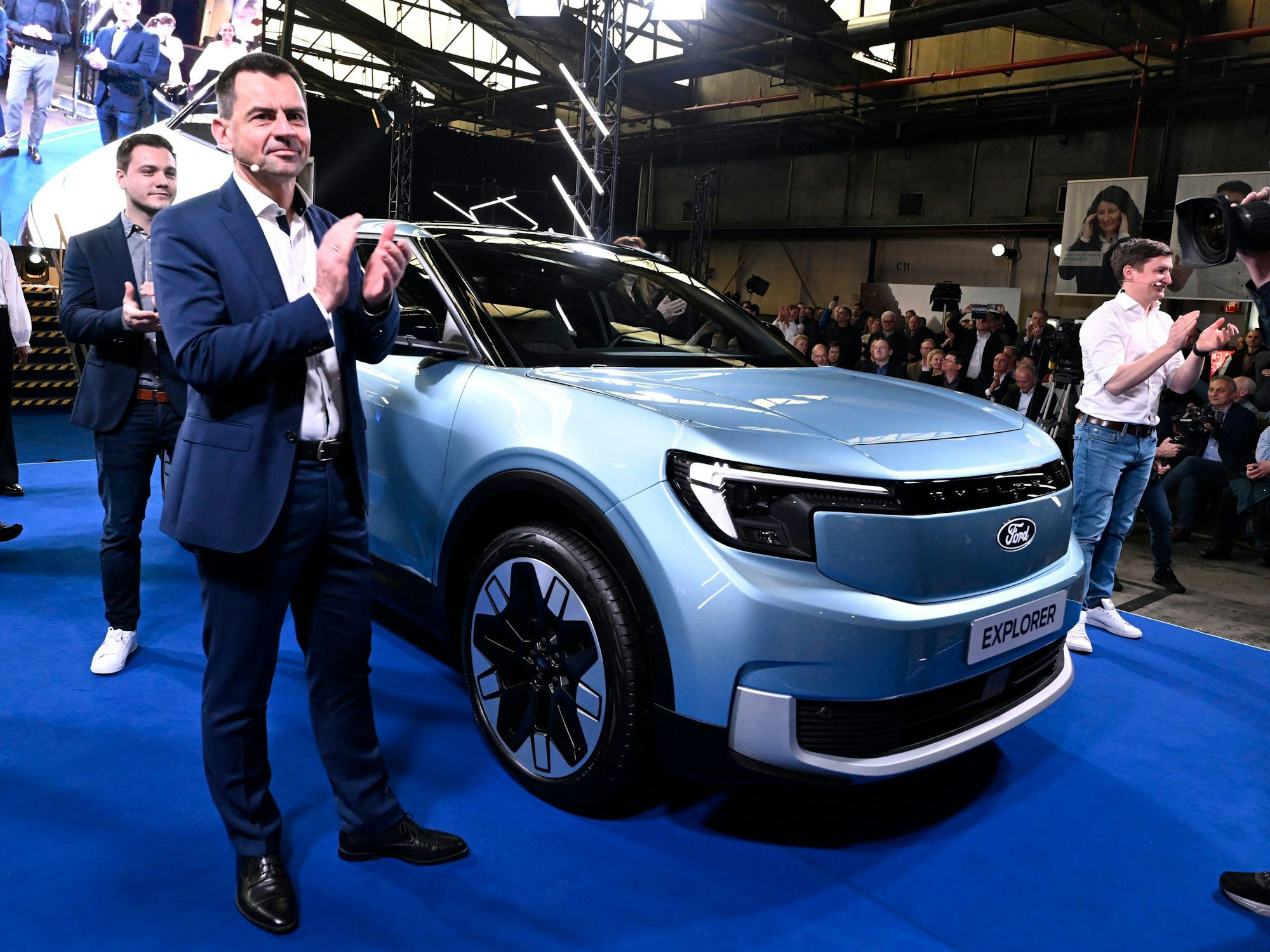 Martin Sander steht neben einem Auto und klatscht in die Hände.