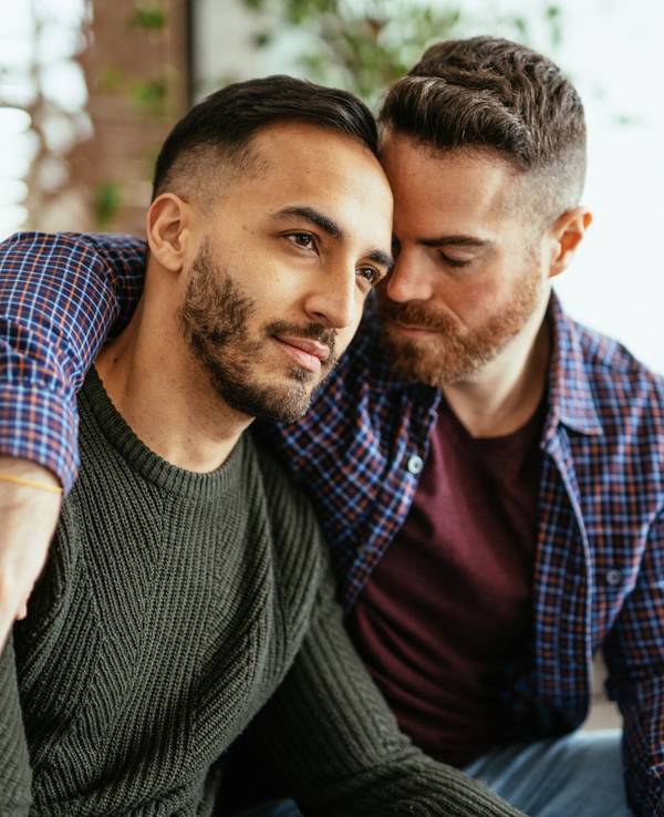 Multi ethnic gay couple at home