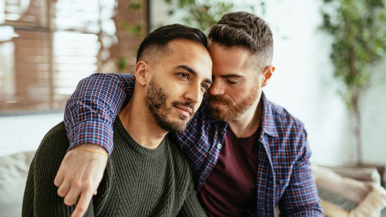 Multi ethnic gay couple at home