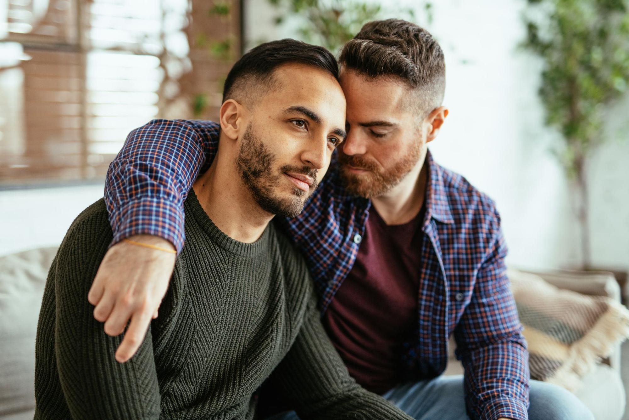 Multi ethnic gay couple at home