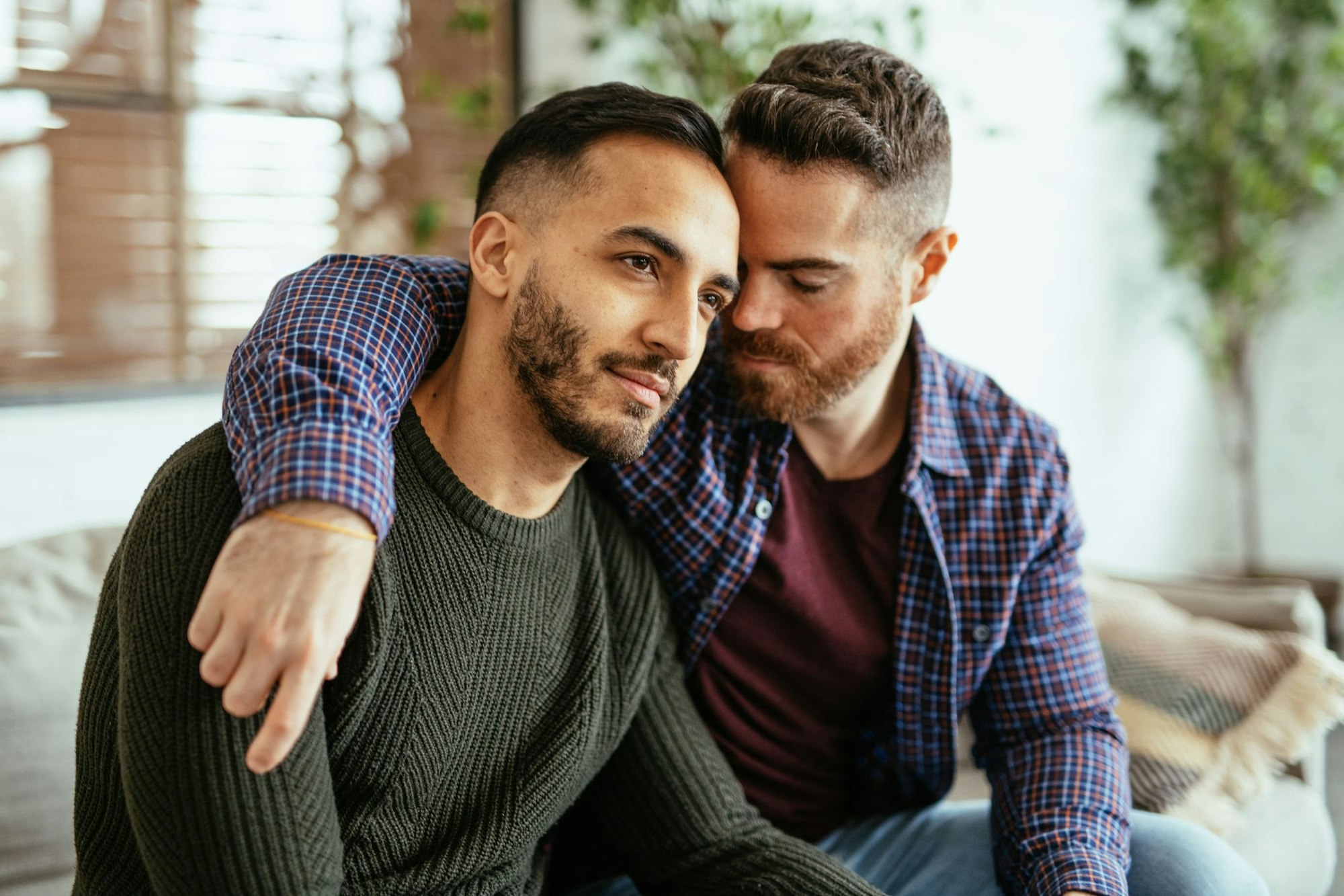 Multi ethnic gay couple at home