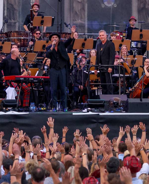 Brings und das Beethoven Orchester Bonn stehen vor dem Kölner Dom auf einer Bühne und spielen Musik.