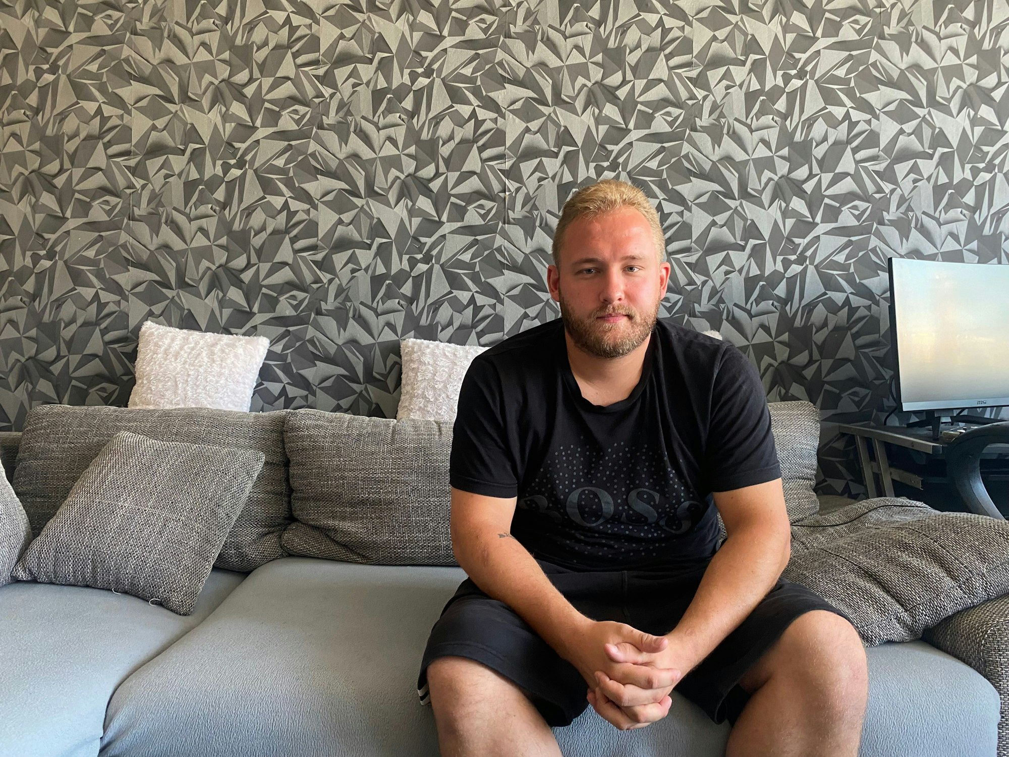 Kevin Niestroj sitzt auf seinem Sofa.